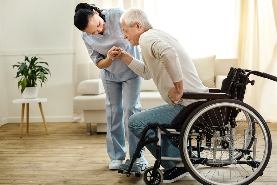 Physical disability. Nice sad aged man holding a caregivers hand and trying to get up while having a physical disability in Glenolden, PA Physical disability. Nice sad aged man holding a caregivers hand and trying to get up while having a physical disability in Glenolden, PA