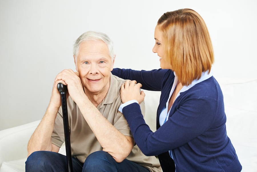 Daughter doing elderly care of senior man at home in Media, PA