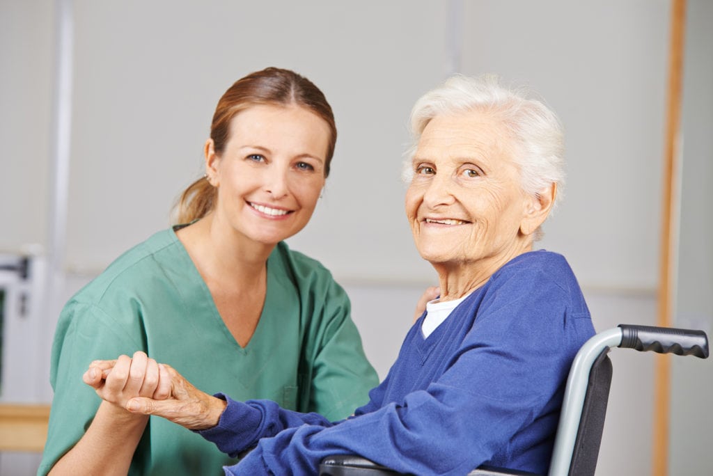 Geriatric care with nurse and happy senior woman in a wheelchair in Bryn Mawr, PA