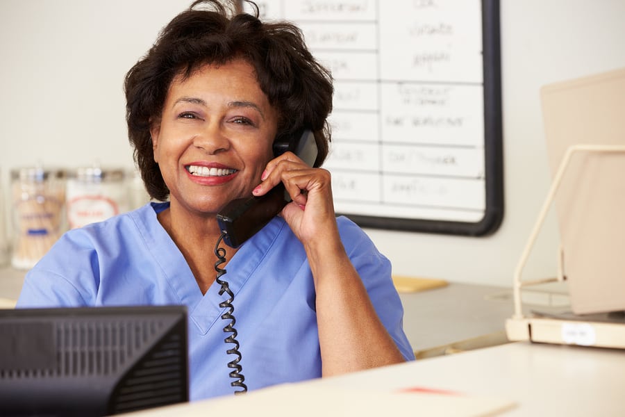 Nurse Making Phone Call At Nurses Station in Glenolden, PA Nurse Making Phone Call At Nurses Station in Glenolden, PA